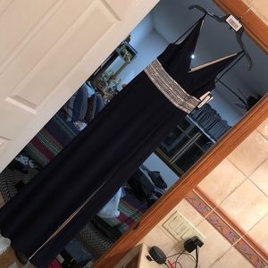 Navy maxi dress gown with silver accents around waist, deep v neck